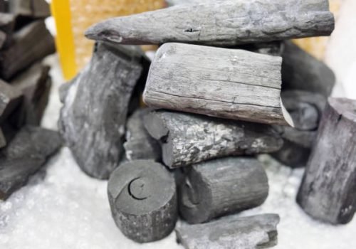 Black coal in a pile on a white background, close-up